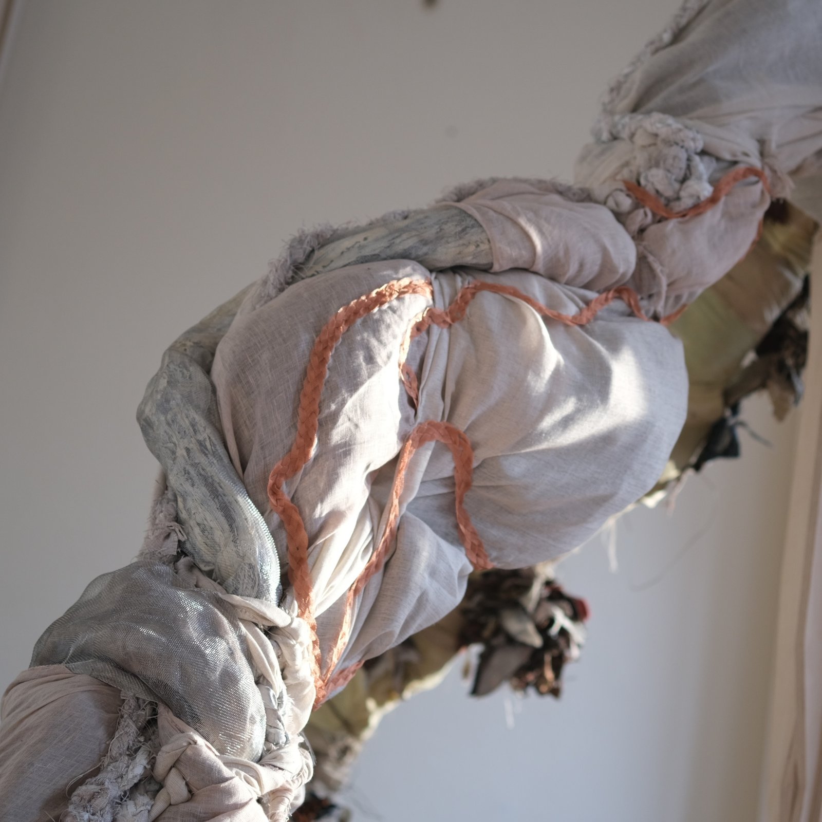 Close-up of sand colored fabric folds on the sculpture